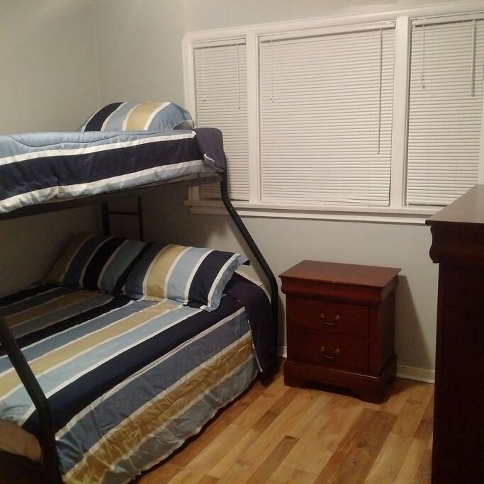 Third bedroom with a twin over double bunk bed.