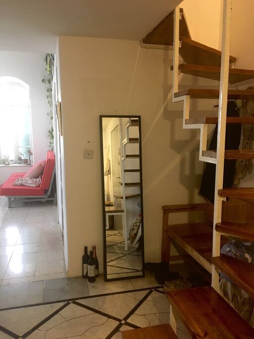 Entrance and stair case to open mezzanine and bathroom