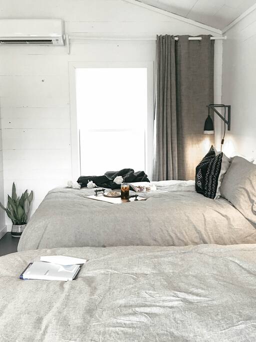 Two queen size comfortable beds complete with down comforters and cotton sheets.