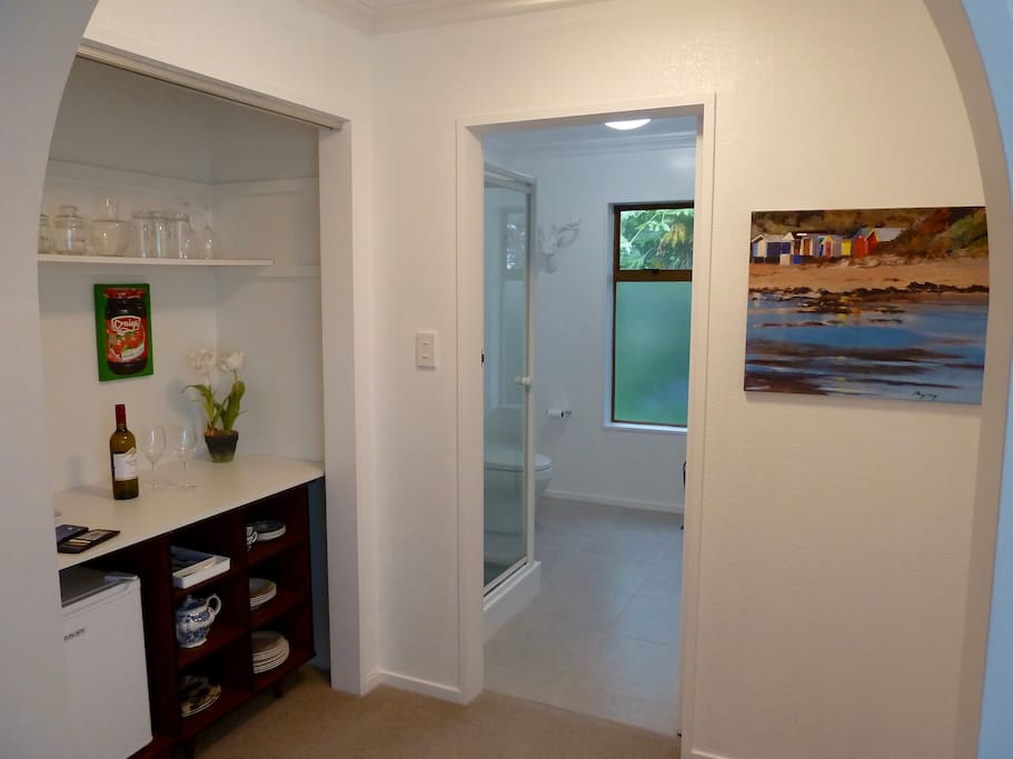 From kitchen area looking through to bathroom. Opposite kitchen is a wardrobe with shelves and large hanging space.