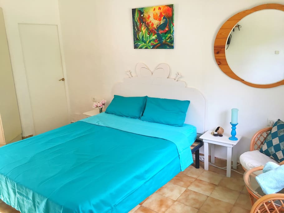 Lovely bright room with a king size bed, your own bathroom, seats and a table, lots of storage and access from the room to the beautiful shared roof terrace, garden & pool.