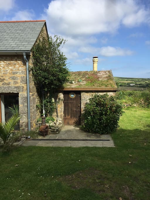 Outside the Cornish Bothy. There's a picnic table and chairs outside in the courtyard which you're welcome to use.