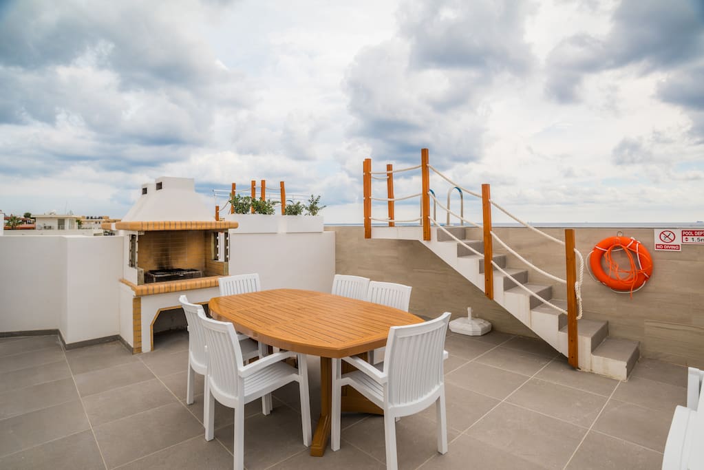 Outdoor Area equipped with; table, chairs and barbecue