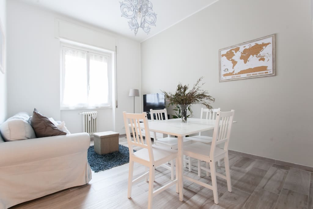 The living room with tv, bed sofa, the dining table