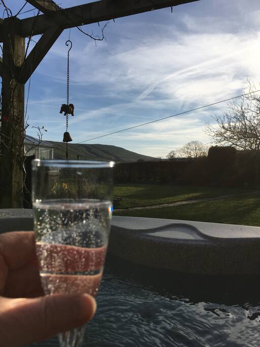 Enjoying the hot tub in the evening sun! (Plastic glass of course)