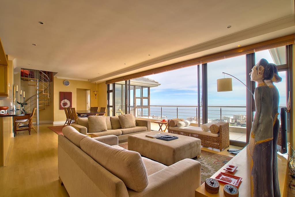 Lounge/TV/dining area with open plan kitchen, access to balcony.