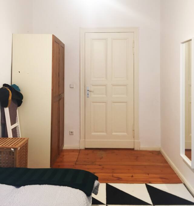 Room with closet, mirror and small table