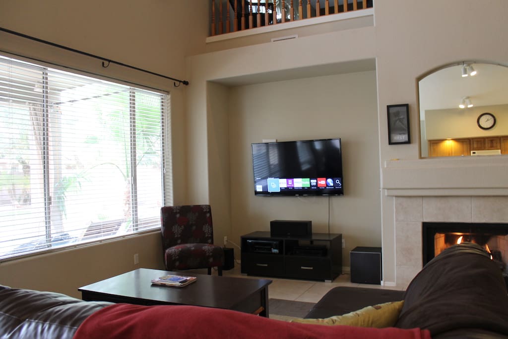 Family room with 55" Smart TV opening to kitchen