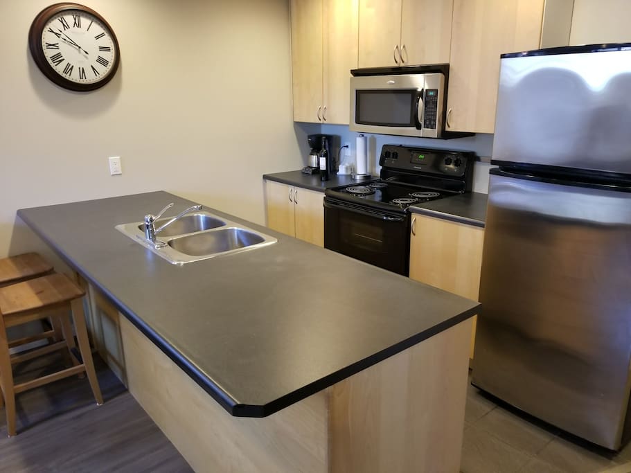 Full 4 piece kitchen with breakfast bar Dishwasher, StoveTop, Oven, Microwave, Double Sink. Fridge/Freezer. Coffee Maker and many other utensils, crockery and appliances. Plenty of space for food and drink. Ice Included.