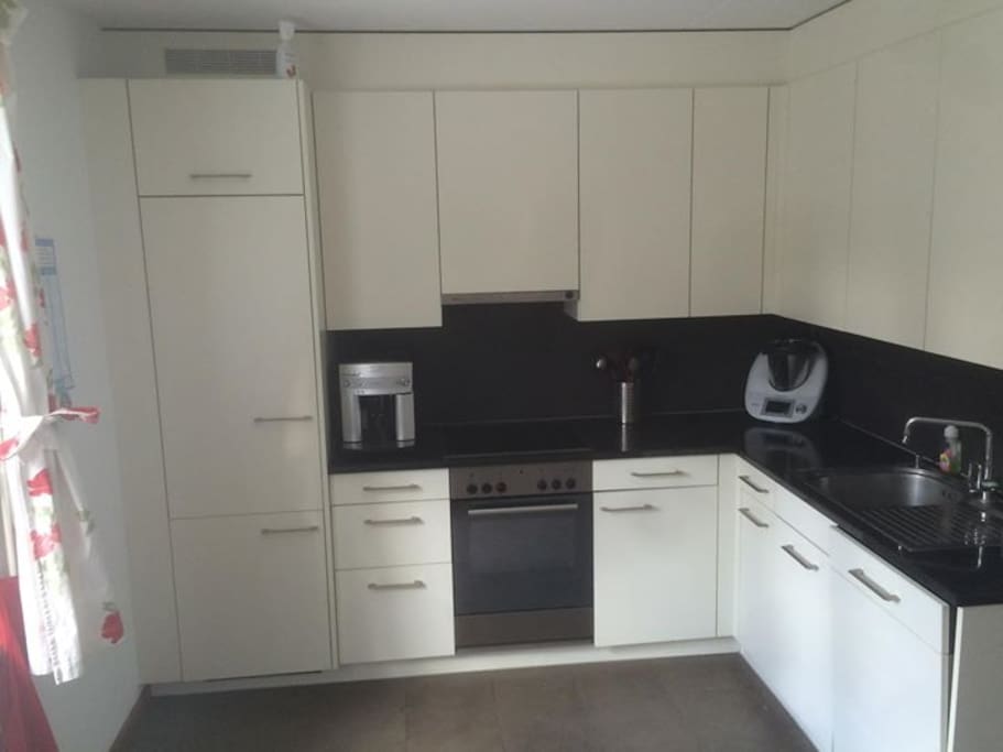modern fully equipped kitchen including coffee machine and dishwasher.