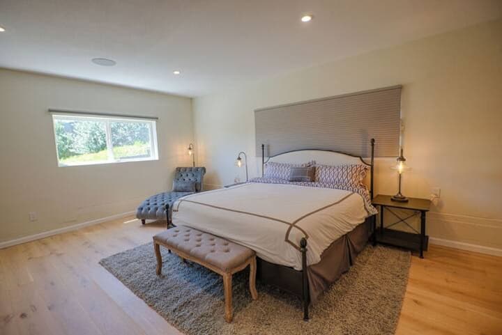 Bedroom #4: Downstairs Master Suite features a 75 inch TV with DirectTV and a lounge sofa. Accessible via Garage -  no steps required.