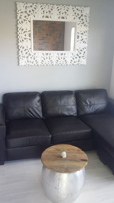 L-shaped sofa perfect for entertaining with views of the mountains and indigenous South African landscape.