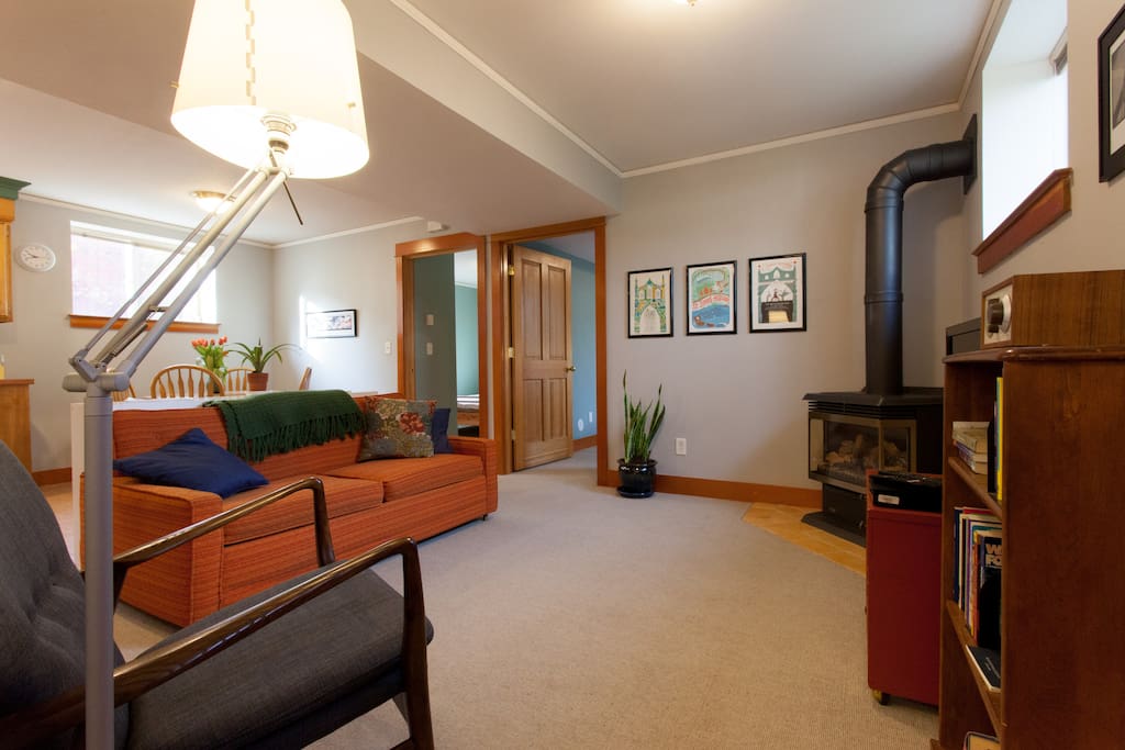 Living room with gas fireplace, TV, and couch with pull-out double bed.