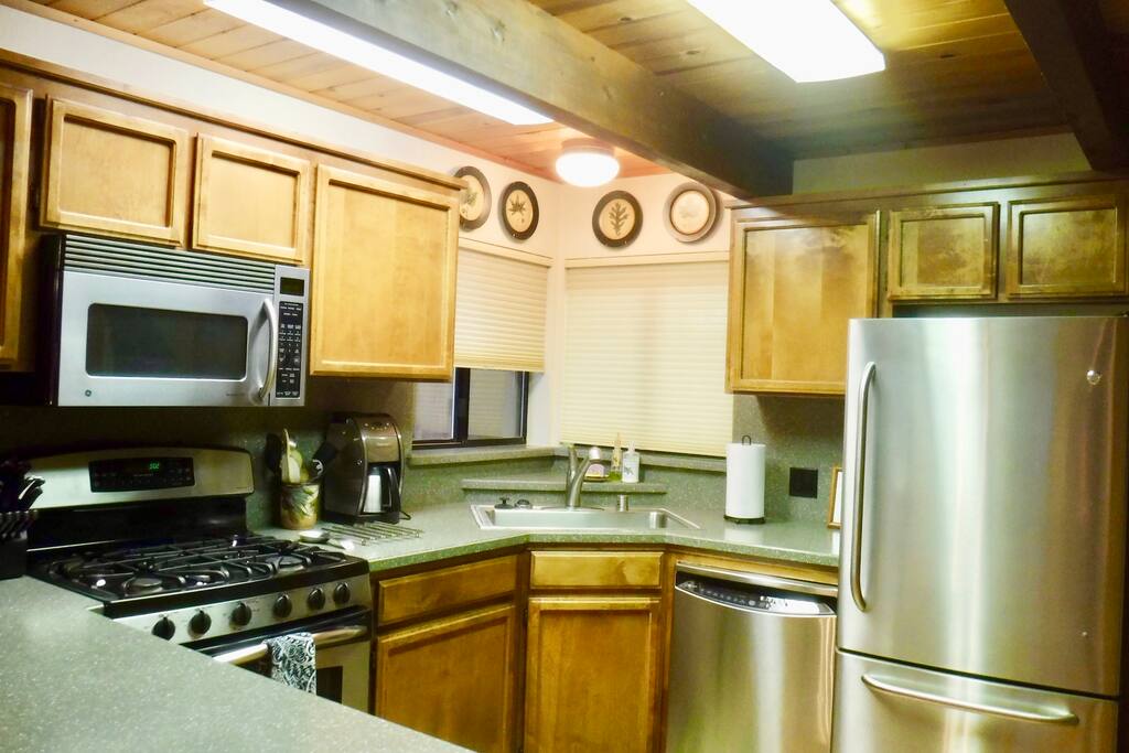 Modern kitchen with stainless steel appliances.