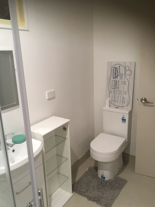 What can we say. Bathroom with , Toilet , vanity , small cabinet and shower.