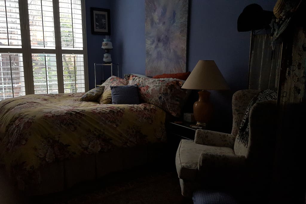 Cozy bedroom looking out at garden.