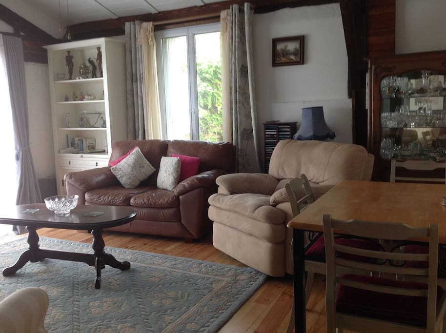 Comfy chair and settee looking out patio doors to the chateaux