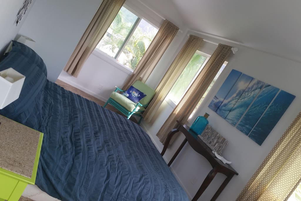 Master bedroom with Cal King, 4 large sliding glass windows allowing cool tradewinds to pass through, and views of the Ko'olau Mountains are gorgeous.