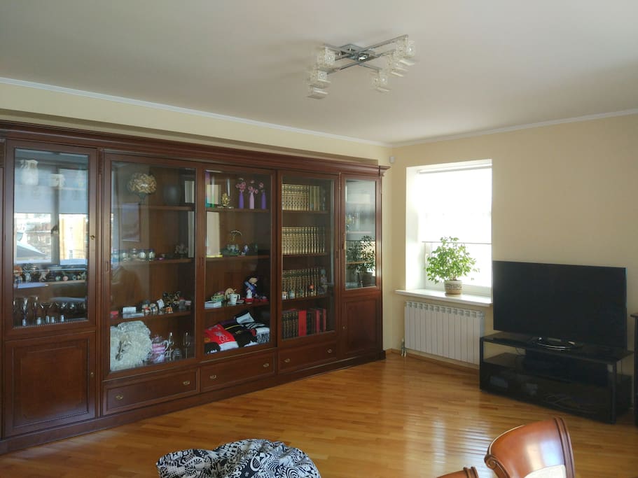 large living room with a big sofa-bed, table for 6, LD TV set, air conditioner