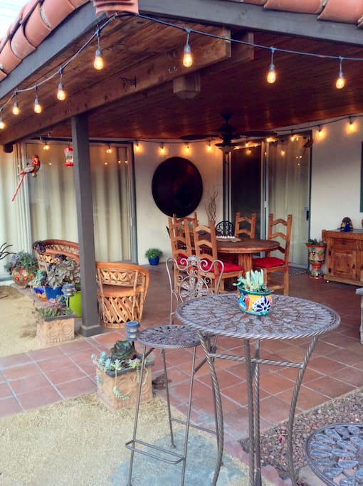 Party lights and misters create ambiance for covered patio