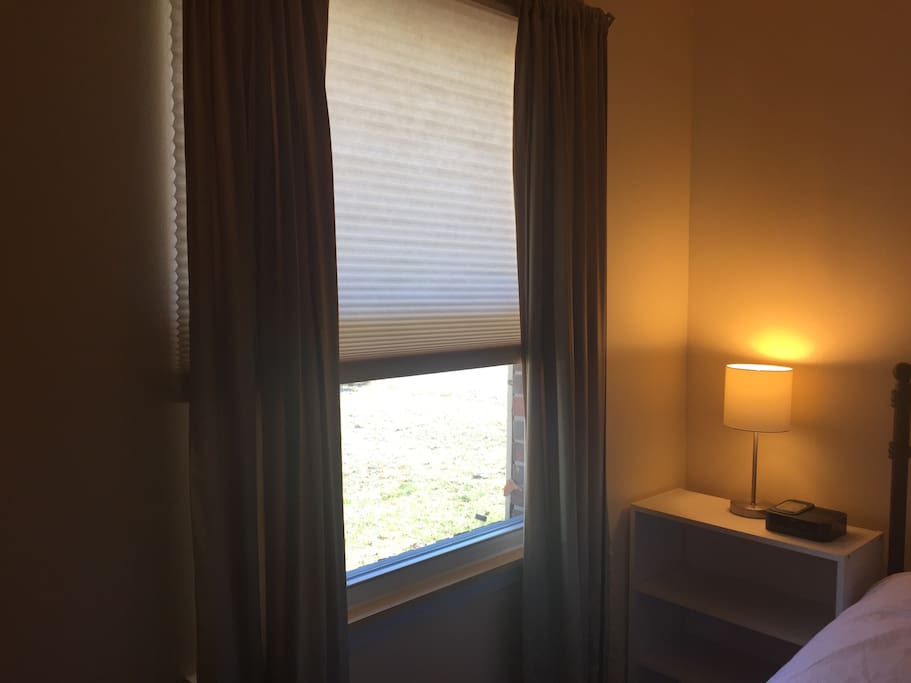 Large window that overlooks the front yard. Light streams in the morning but curtains are light-blocking if you want to keep the sun out.