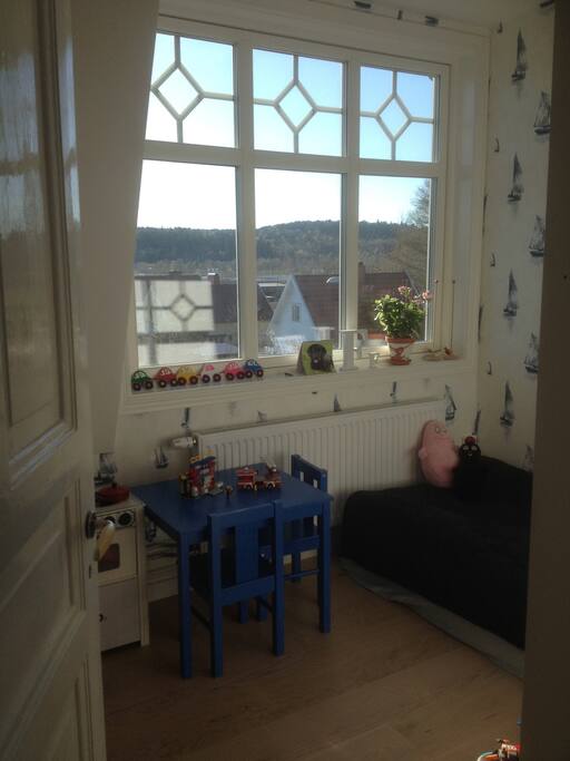 Small bedroom with one bed and a lovely window with view.