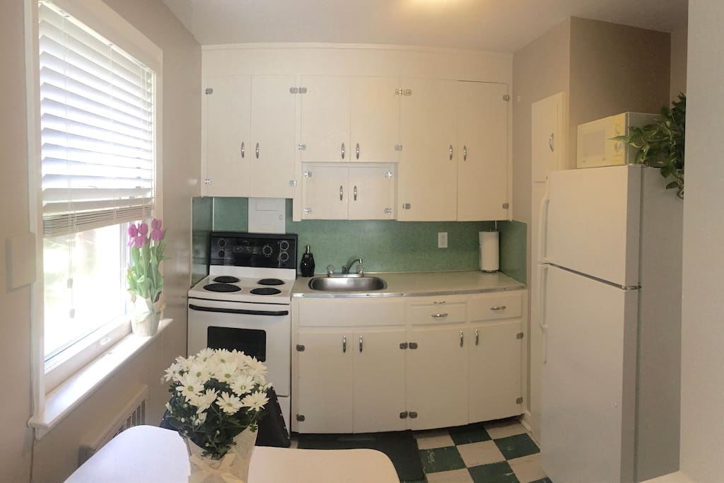 Bright eat-in kitchen, fully stocked with everything you'll need to prepare your own meals in the apartment.