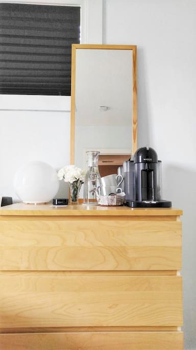 Dresser, Nespresso coffee machine, Amazon Echo, water carafe