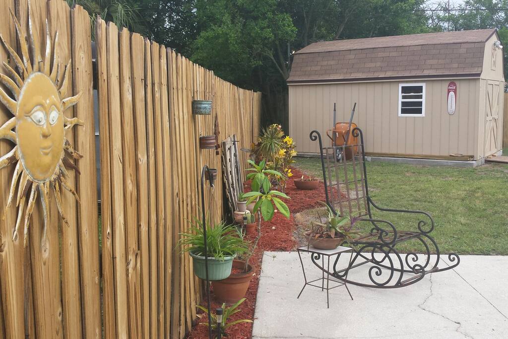 Our big backyard, with tables, chairs and umbrella for your use
