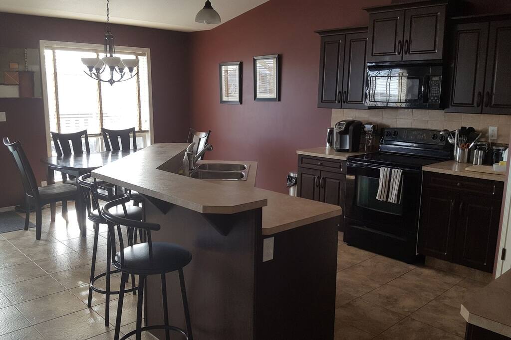 full kitchen with appliances, dishes, pans, etc