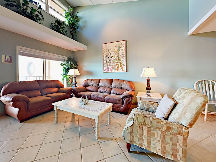 A plush armchair offers a relaxing seat to curl up with a book.