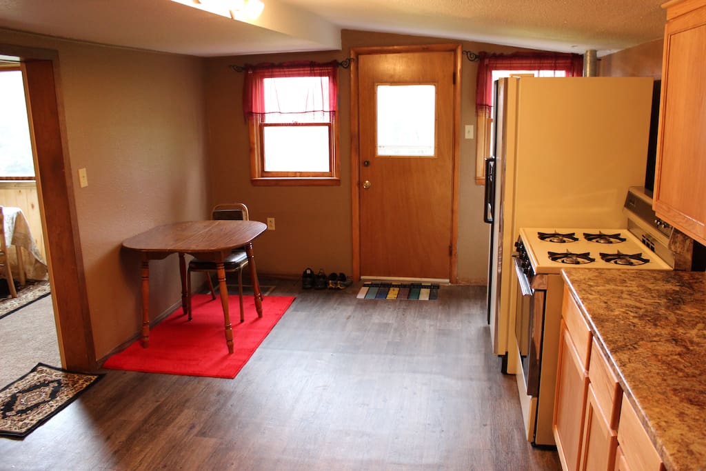 Kitchen looking out to the side door leading to the deck.