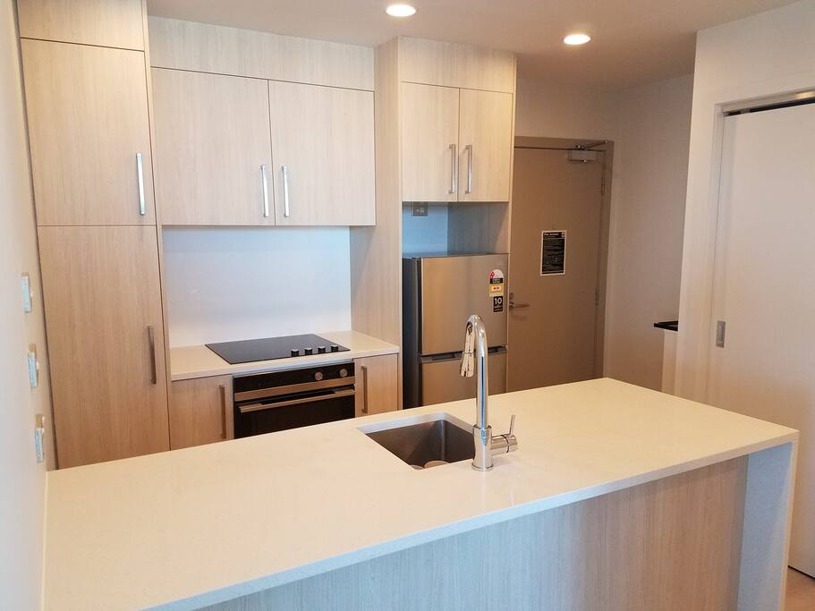 Kitchen with dishwasher, oven, fridge and microwave