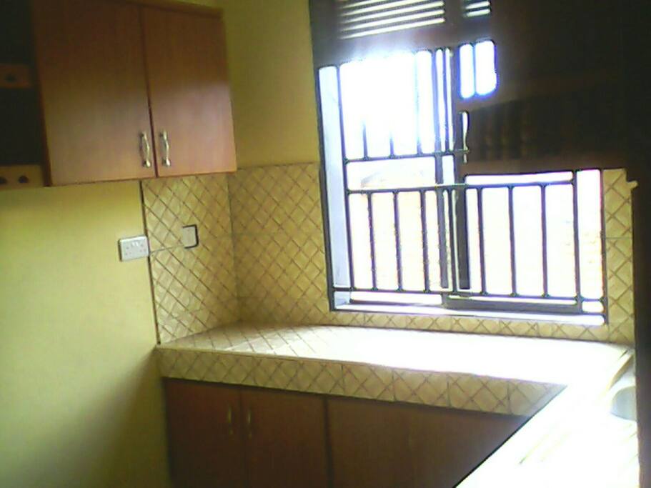 Kitchen with in-built cupboards, a fridge and gas cooker