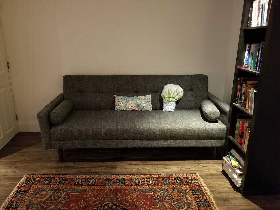 Lovely living space, including a pull-out Crate and Barrell Sofa.