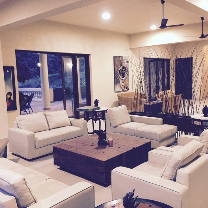 Living Room With Many Paintings and Handmade Sculptures
