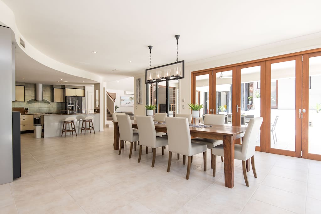 Comfortable 8 seater dining with bi-fold doors to the pool area