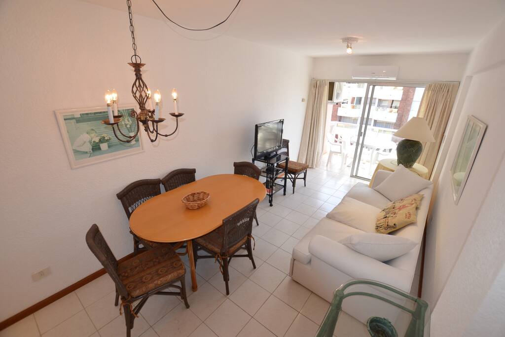 Dining room with table for 6. Air conditioner and tv cable