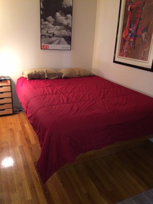 New Queen size Stearns and Foster bed in 7x13 sleeping alcove w/ end table and dresser.