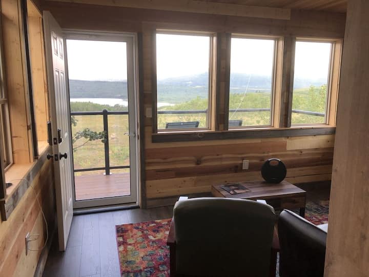 Upper living area with upper viewing deck and staircase to the ground floor.