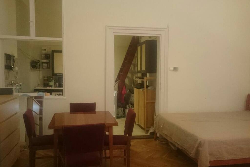 "Social area" :) with a table and 4 chairs. Behind me is a big wardrobe with a large mirro