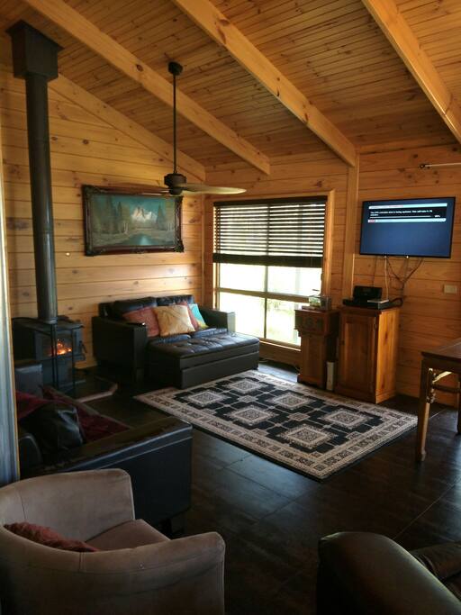 Living area with Pay Tv, wood fire and split system heating/cooling
