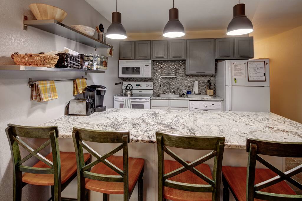 Kitchen - brand new and fully-equipped with bar seating