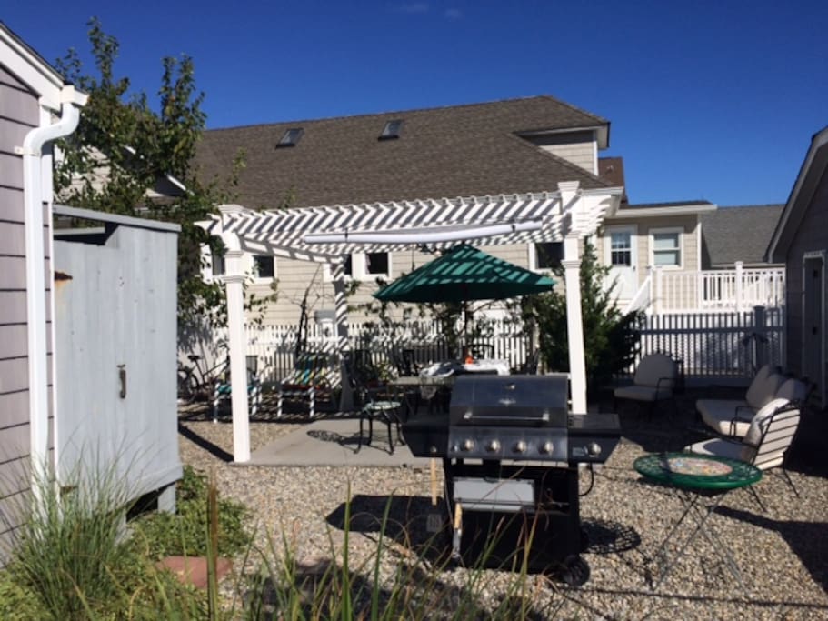 Spacious private outdoor patio with lots of seating and shade. gas grill and outdoor shower