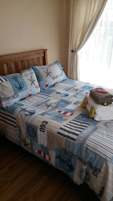 Spacious bedroom with double bed and on suite bathroom.