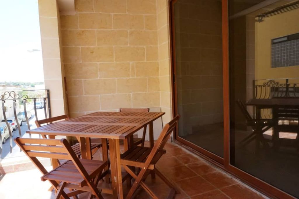 Large Front Balcony with outdoor wooden table and chairs which can be folded and stored when not in use.