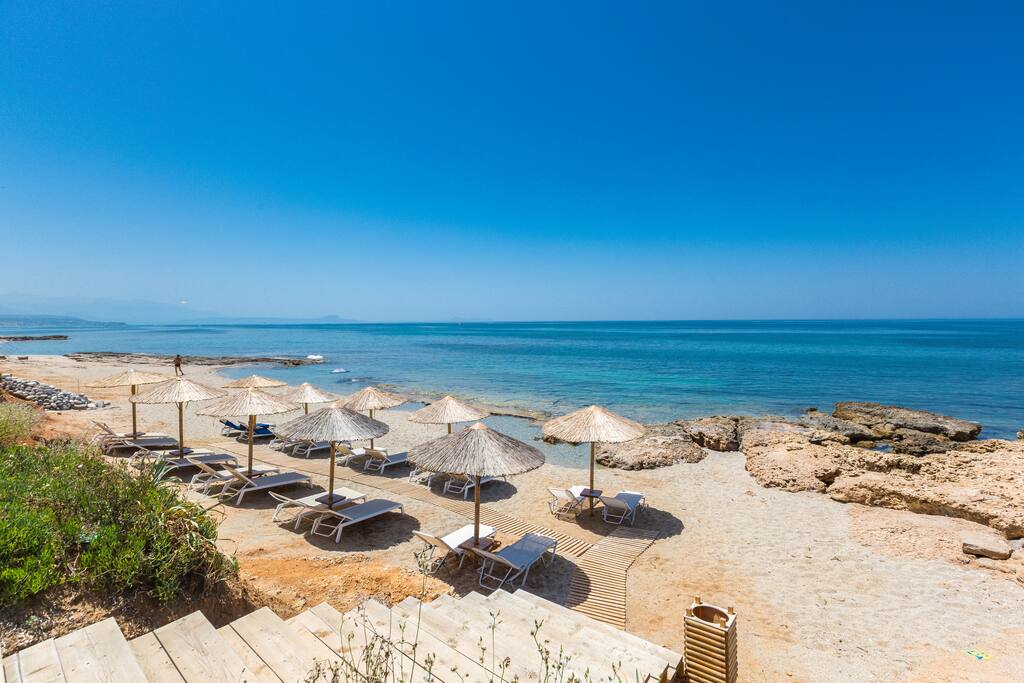 Private beach with sun beds on the crystal clear water's edge