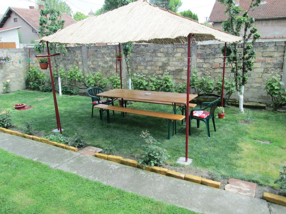 The patio cover with table, benches and chairs