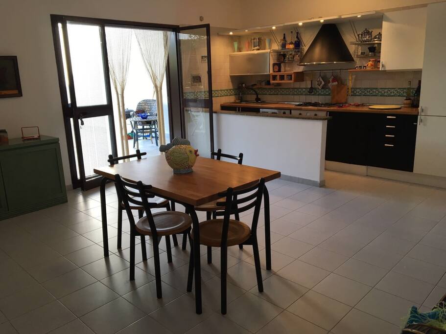 The spacious living room with the wooden table and chairs