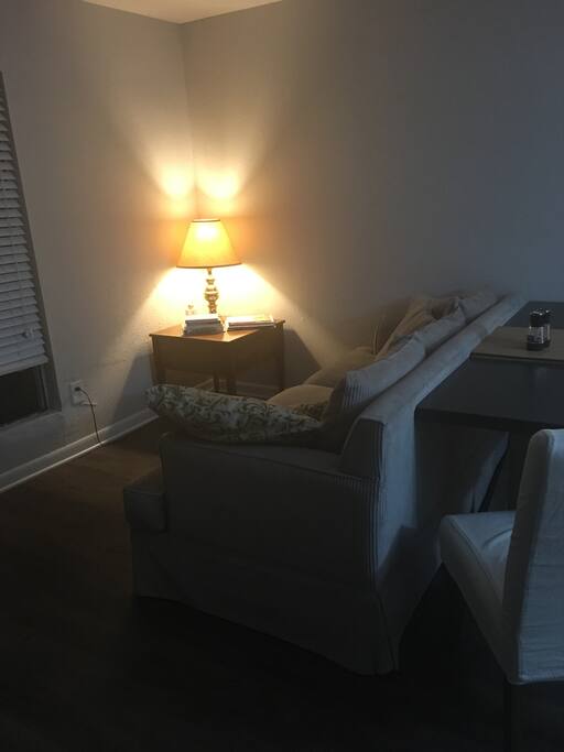 Table that you can't see is to the left of the couch. Currently situated to seat three but easily scooted to seat 6+